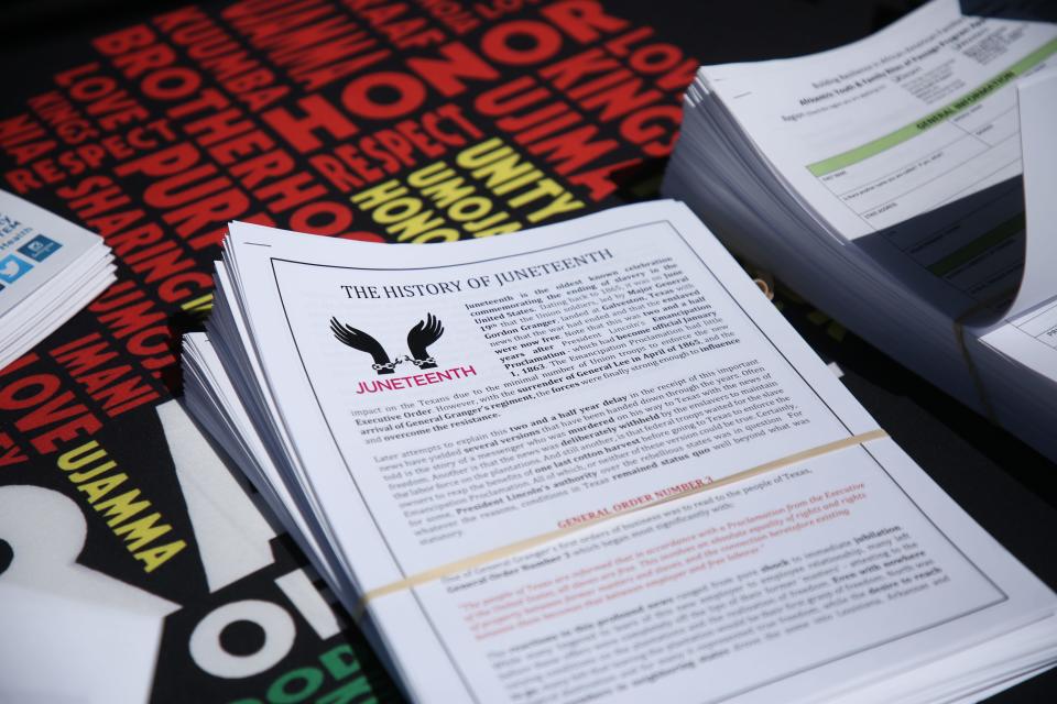 Information about Juneteenth sits on a table at James O. Jessie Desert Highland Unity Center during a Juneteenth barbecue on June 19, 2020 in Palm Springs, Calif.