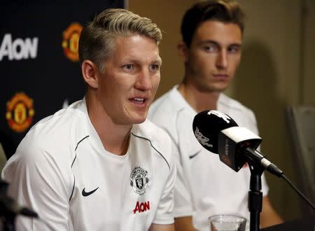 Manchester United's Bastian Schweinsteiger (L) speaks to the media as teammate Matteo Darmian looks on after they and Morgan Schneiderlin (unseen) were introduced as the club's new signings at a news conference in Bellevue, Washington July 15, 2015. REUTERS/Jason Redmond