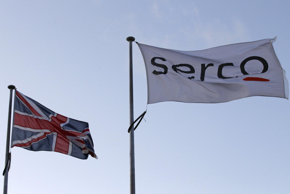 A Serco flag is seen flying alongside a Union flag outside Doncaster Prison in northern England in this December 13, 2011 file photograph. Britain on July 11, 2013 launched a review into all contracts held by outsourcing firms G4S and Serco after an audit found evidence they had charged for tagging criminals who were either dead, in prison or never tagged in the first place.   REUTERS/Darren Staples/Files   (BRITAIN - Tags: CRIME LAW SOCIETY POLITICS)