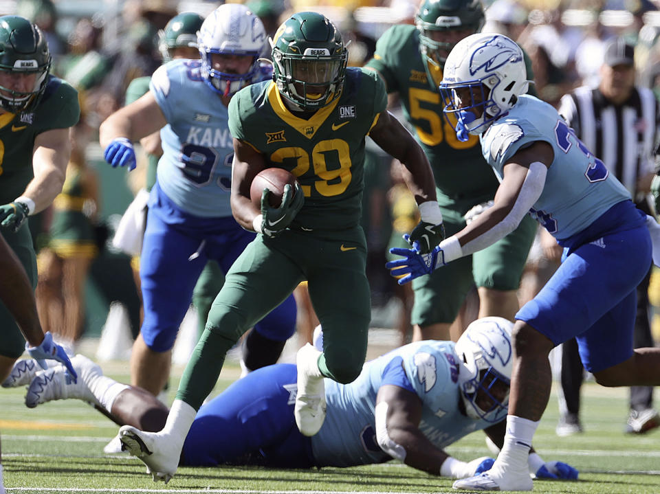 FILE - Baylor running back Richard Reese, center, runs through the Kansas defense in the first half of an NCAA college football game Oct. 22, 2022, in Waco, Texas. Baylor opens their season at home against Texas State on Sept. 2. (AP Photo/Jerry Larson, File)