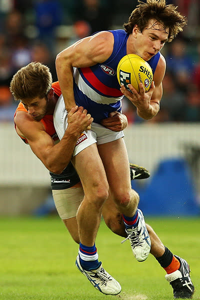 BALL: Jed Lamb gets a hold of Bulldogs Liam Picken as he tries to dish the ball off