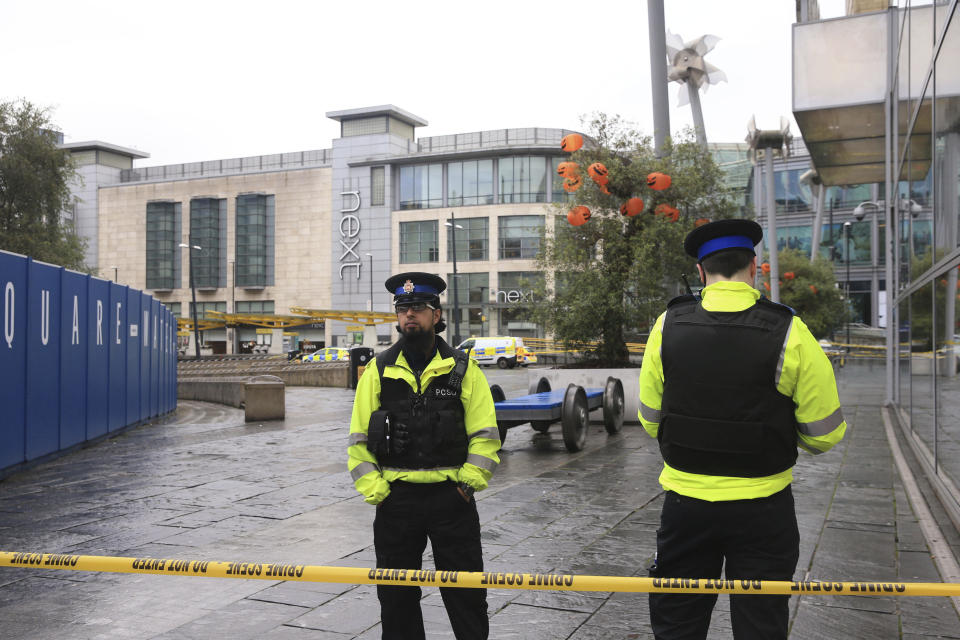 Police outside the Arndale Centre in Manchester, England, Friday October 11, 2019, after a stabbing incident at the shopping center that left four people injured. Greater Manchester Police say a man in his 40s has been arrested on suspicion of serious assault. He had been taken into custody. (Peter Byrne/PA via AP)