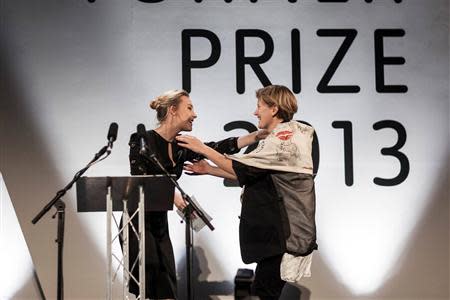 French-born film installation artist Laure Prouvost (R) embraces Irish actress Saoirse Ronan after Ronan awarded Prouvost with this year's Turner Prize, in Londonderry, Northern Ireland December 2, 2013. RREUTERS/robertemmett.co.uk/City of Culture 2013/Handout via Reuters