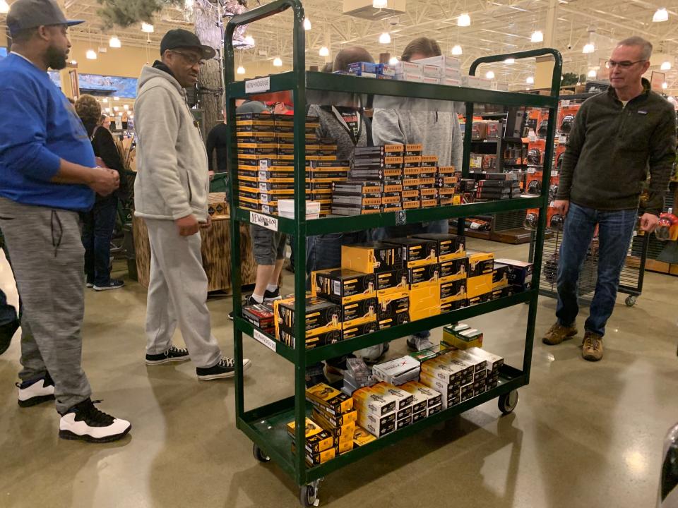 Shoppers visit an ammunition rack at Cabela's on Tuesday, March 17, 2020.