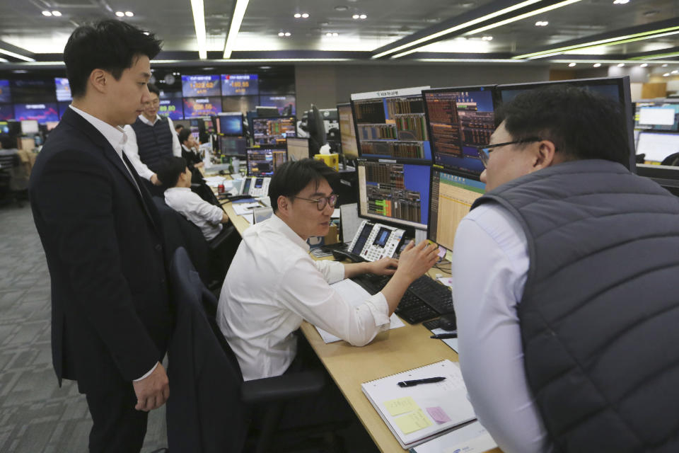 Currency traders work at the foreign exchange dealing room of the KEB Hana Bank headquarters in Seoul, South Korea, Thursday, Dec. 5, 2019. Asian shares were rising Thursday amid renewed hopes a U.S. trade deal with China may be nearing, despite tough recent talk from President Donald Trump.(AP Photo/Ahn Young-joon)