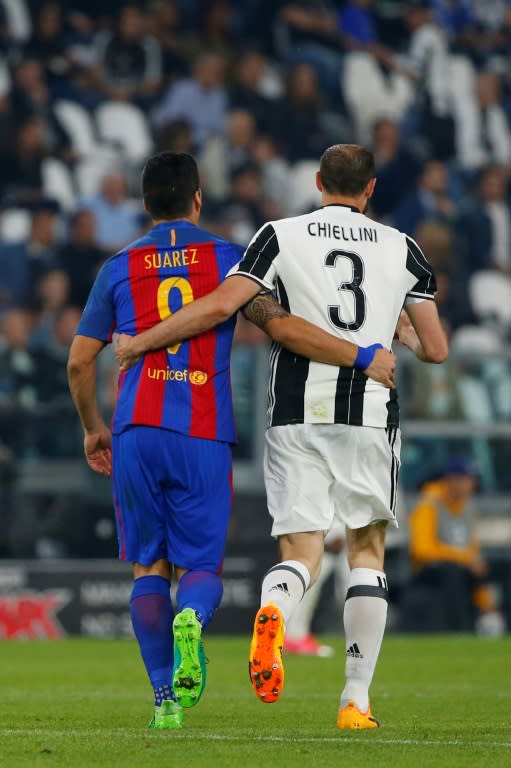 Barcelona's forward Luis Suarez (L) and Juventus' defender Giorgio Chiellini walk together during the UEFA Champions League quarter final first leg football match Juventus vs Barcelona, on April 11, 2017