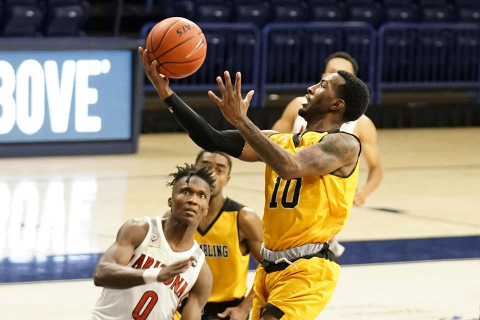 Grambling guard Trevell Cunningham drives past Arizona guard Bennedict Mathurin (0) during the first half of an NCAA college basketball game Friday, Nov. 27, 2020, in Tucson, Ariz. (AP Photo/Rick Scuteri)