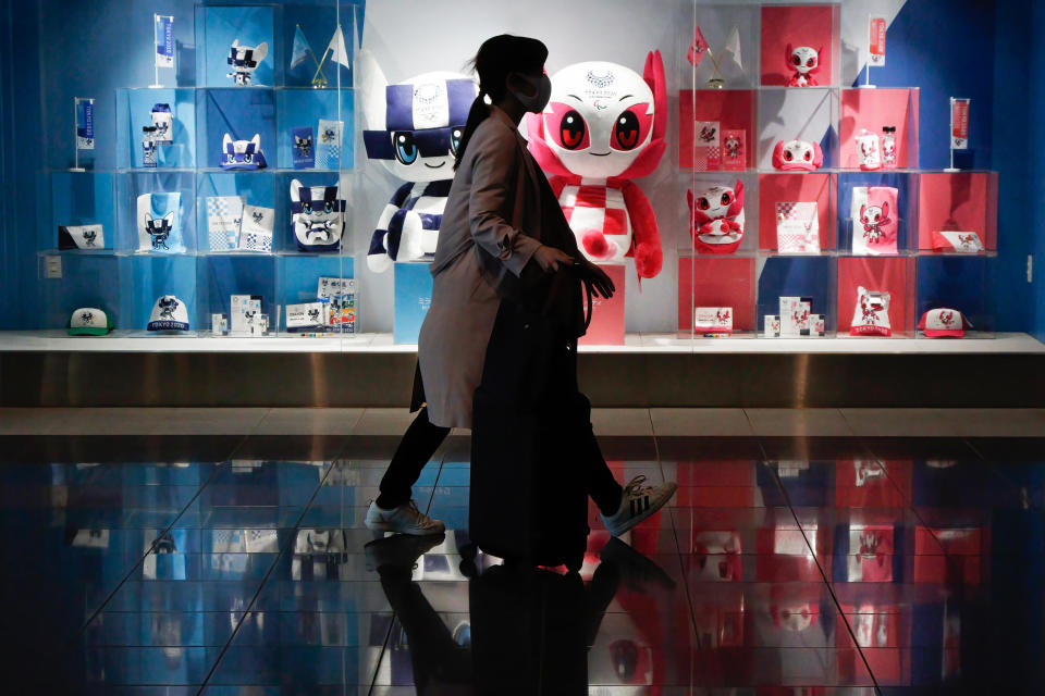 A shopper walks past the official shop of the Tokyo Olympics 2020 in Tokyo, April 25, 2021. / Credit: James Matsumoto/SOPA Images/LightRocket/Getty