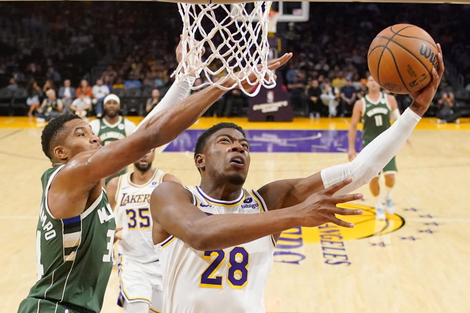 Los Angeles Lakers forward Rui Hachimura, right, shoots as Milwaukee Bucks forward Giannis Antetokounmpo defends during the first half of an NBA preseason basketball game Sunday, Oct. 15, 2023, in Los Angeles. (AP Photo/Mark J. Terrill)