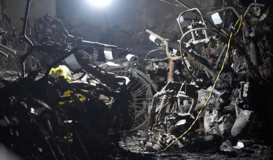 Burned vehicles are left at the site of a fire in an apartment building in Hanoi, Vietnam Thursday, Sept. 14, 2023. A fire broke just before midnight Tuesday in the apartment building that killed scores of people. (AP Photo/Hau Dinh)