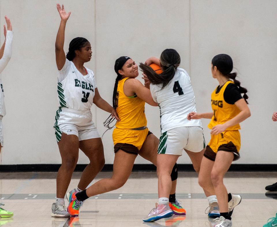 Stagg's Kayla Ogle, center, fights for the ball with McNair's Saniyah Robinson, left, and Malia Do during a SJAA girls varsity basketball game at McNair in Stockton on Feb 1. 2024.