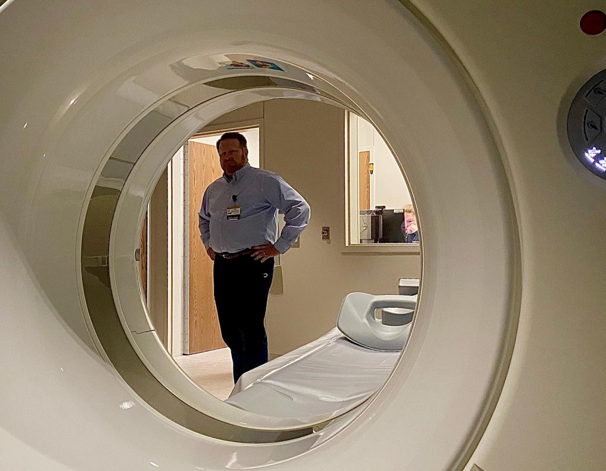 Bill Keller, MU Health Care radiology manager, explains at CT scanners to people touring the new Jackson Road Medical Building during its grand opening on April 11, 2023, in Boonville, Mo.