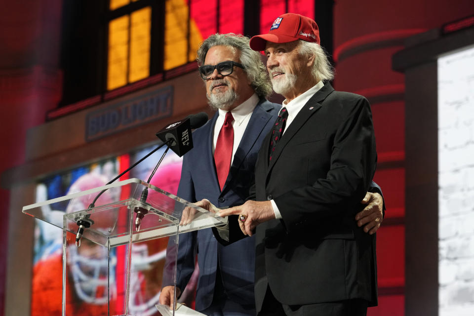 FILE - Ed Budde, right, and Brad Budde announce the No. 55 pick for the Kansas City Chiefs at the NFL football draft April 28, 2023, in Kansas City, Mo. The Chiefs picked SMU wide receiver Rashee Rice. Ed Budde, who spent 14 years playing along the offensive line of the Chiefs and helped the franchise win its first Super Bowl with a victory over Minnesota in 1970, died Tuesday, Dec. 19, 2023. He was 83. The family announced his death through a statement issued by the Chiefs. No cause of death was provided. (AP Photo/Steve Luciano, File)