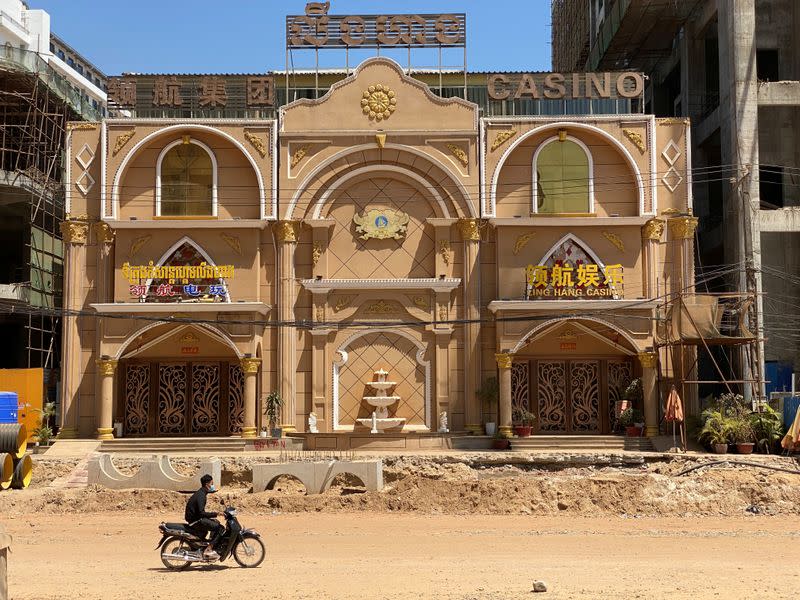 Motorbike drives past a closed casino in Sihanoukville