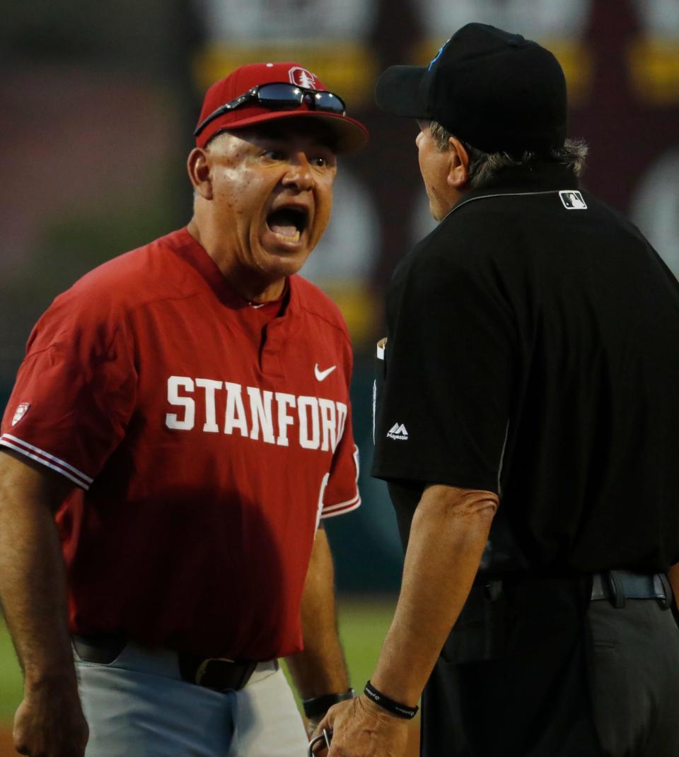 Stanford's head coach David Esquer argues with home plate umpire Joe Burleson after a ground rule double was changed to a home run during the sixth inning at Phoenix Municipal Stadium in Phoenix, Ariz. on May 24, 2019. 