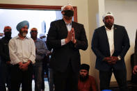 Rep. Andre Carson, D-Ind., speaks with members of the Sikh Coalition at the Sikh Satsang of Indianapolis in Indianapolis, Saturday, April 17, 2021, for a commemoration of the victims of the shooting at a FedEx facility in Indianapolis that claimed the lives of four members of the Sikh community. A gunman killed eight people and wounded several others before taking his own life in a late-night attack at a FedEx facility near the Indianapolis airport. (AP Photo/AJ Mast)