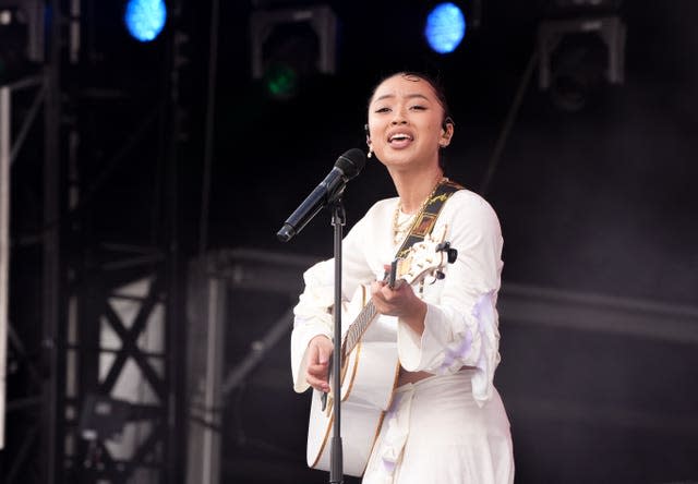 Griff performing in a all-white outfit