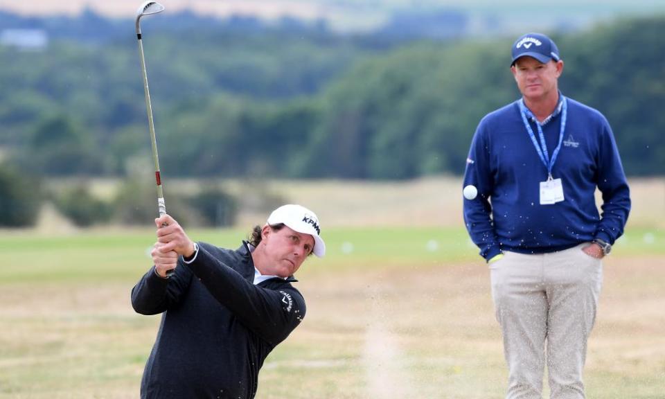 Phil Mickelson plays from the bunker in front of coach Andrew Gettison during practice at Gullane.