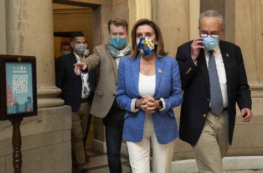 House Speaker Nancy Pelosi of Calif., and Senate Minority Leader Chuck Schumer of N.Y., walk from Pelosi's office following a meeting at the Capitol with White House chief of staff Mark Meadows and Treasury Secretary Steven Mnuchin on a COVID-19 relief bill, Saturday, Aug. 1, 2020, in Washington. (AP Photo/Manuel Balce Ceneta)