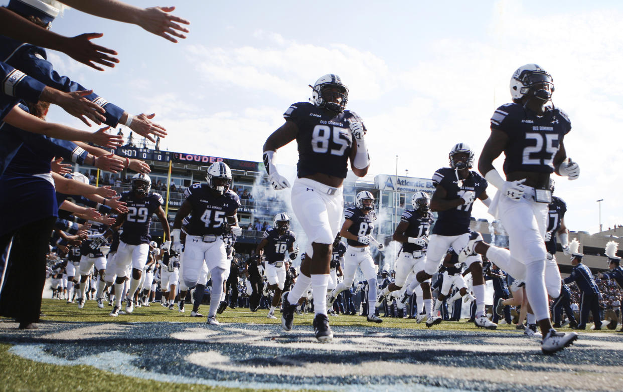 Old Dominion University players run onto the field for an NCAA college football game against North Carolina, Saturday, Sept. 16, 2017 in Norfolk, Va.