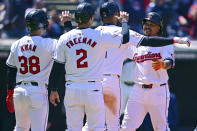 Cleveland Guardians' Jose Ramirez, right, is congratulated by Gabriel Arias (13), Tyler Freeman (2), Steven Kwan (38) after hitting a grand slam off Boston Red Sox starting pitcher Chase Anderson during the second inning of a baseball game, Thursday, April 25, 2024, in Cleveland. (AP Photo/David Dermer)