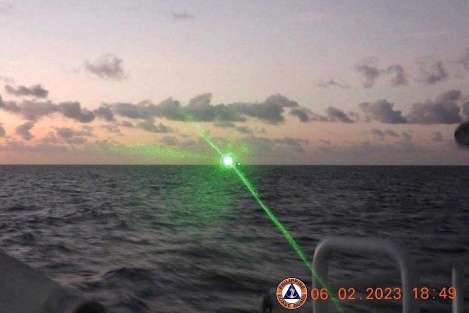A Chinese Coast Guard vessel shining a ‘military grade laser light' at a Philippine Coast Guard boat (Philippine Coast Guard (PCG)/AFP)