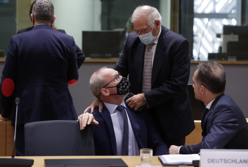 Ireland's Foreign Minister Simon Coveney, center left, speaks with European Union foreign policy chief Josep Borrell, center right, during a meeting of EU foreign affairs ministers at the European Council building in Brussels, Monday, Sept. 21, 2020. European Union foreign ministers on Monday were weighing whether to impose sanctions on dozens of Belarus officials, including President Alexander Lukashenko, after holding talks with the country's exiled opposition leader. (Olivier Hoslet, Pool via AP)