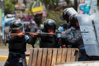 Riot policemen fire rubber bullets toward university students protesting over a controversial reform to the pension plans in Managua. REUTERS/Oswaldo Rivas