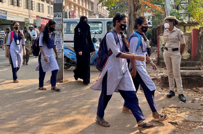 Schoolgirls arrive to attend their classes at a government girls school in Udupi town