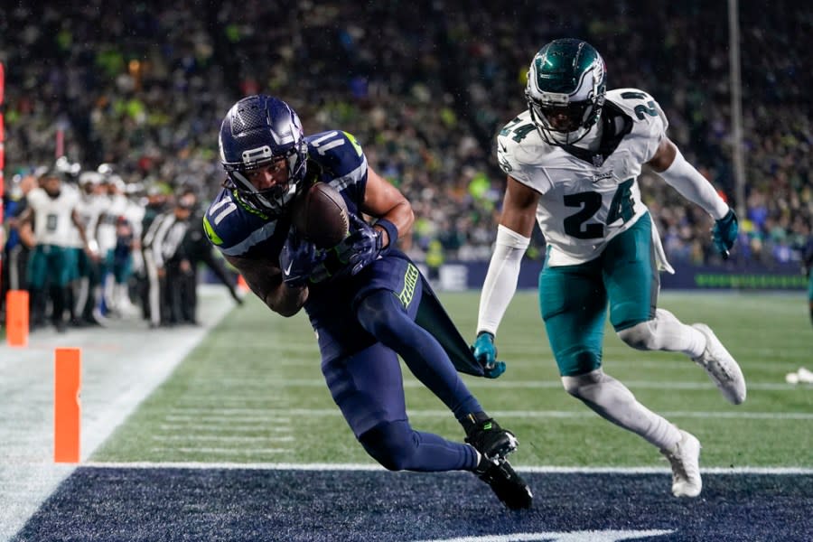 Seattle Seahawks wide receiver Jaxon Smith-Njigba, left, makes a touchdown catch in front of Philadelphia Eagles cornerback James Bradberry (24) during the second half of an NFL football game, Monday, Dec. 18, 2023, in Seattle. The Seahawks won 20-17. (AP Photo/Lindsey Wasson)