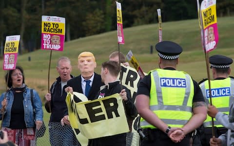 Activists from Stand Up to Racism Scotland (SUTR) stage a protest at the Trump Turnberry resort - Credit: David Cheskin /PA