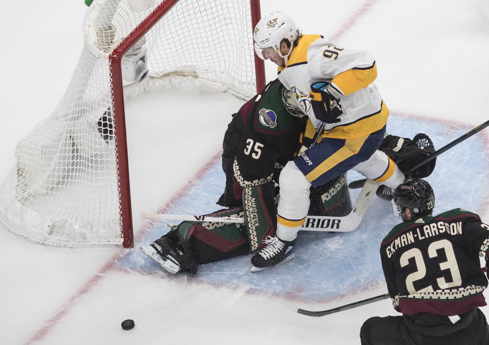 Nashville Predators' Ryan Johansen (92) crashes into Arizona Coyotes goalie Darcy Kuemper (35) during first period NHL qualifying round game action in Edmonton, on Wednesday, Aug. 5, 2020. (Jason Franson/The Canadian Press via AP)