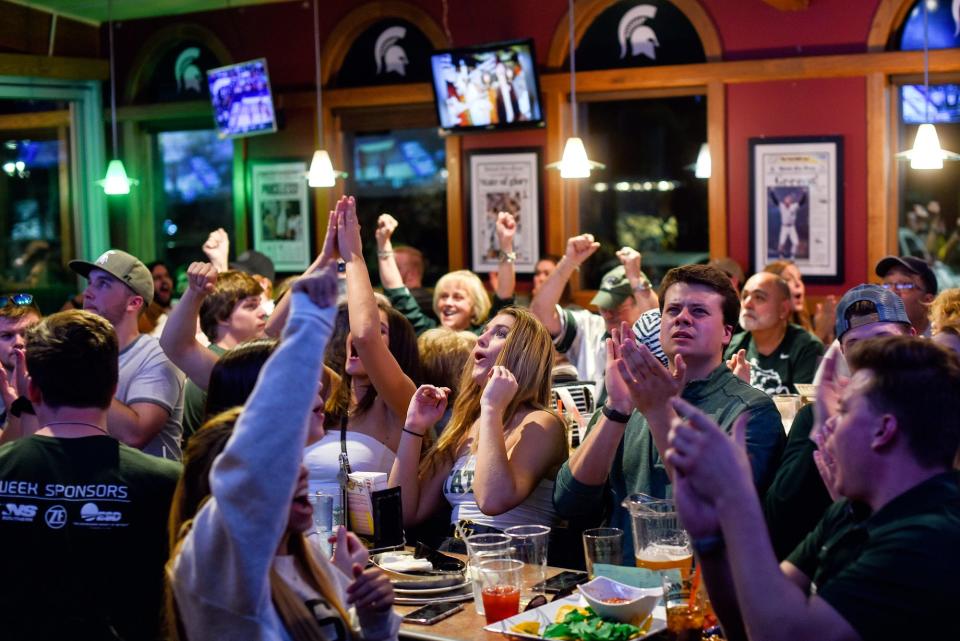 Fans react to a MSU score during the first half the Michigan State Spartans' Final Four game against Texas Tech on Saturday, April 6, 2019, at Reno's East in East Lansing.