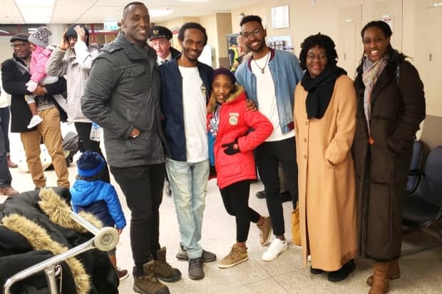 Yusuf Shire in the Fredericton airport welcoming newcomers. 