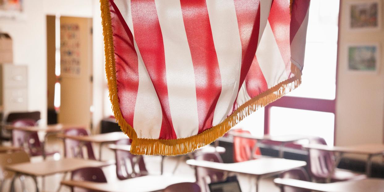 An American Flag hangs in a classroom.