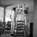<p>The politician and his fiancée observe a wall of portraits inside the Massachusetts home. Three months later, they would <a href="https://www.townandcountrymag.com/the-scene/weddings/g870/jackie-jfk-wedding-photos/" rel="nofollow noopener" target="_blank" data-ylk="slk:go on to marry" class="link ">go on to marry</a> in front of hundreds of guests in Newport, Rhode Island.</p>