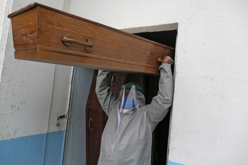 Brazilian evangelical pastor Izaias Nascimento, 49, carries a coffin for a COVID-19 victim before a funeral service in Manaus.