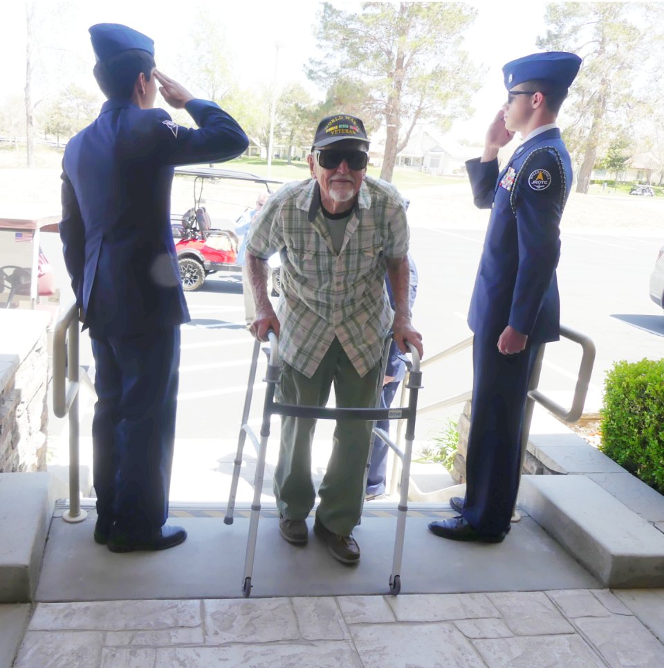 Cadets from the Academy for Academic Excellence’s Space Force Junior ROTC stand and salute World War II veteran and retired Army Air Corps pilot Donald Roser as he arrives at his 99th birthday party on Saturday in Apple Valley.