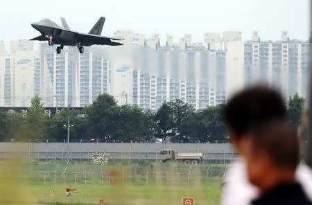 A U.S. Air Force F-22 Raptor fighter jet flies over an apartment complex in Gwangju, South Korea, May 16, 2018. Yonhap via REUTERS