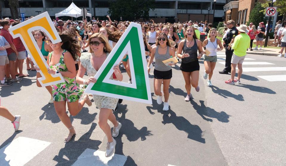 Bid recipients from Alpha Gamma Delta run to their house during the Bid Day activities for the University of Alabama sororities, Aug. 20, 2023, on Sorority Row. Approximately 2,500 incoming freshmen received bids during the Panhellenic Association event.
(Credit: Gary Cosby Jr.-Tuscaloosa News)