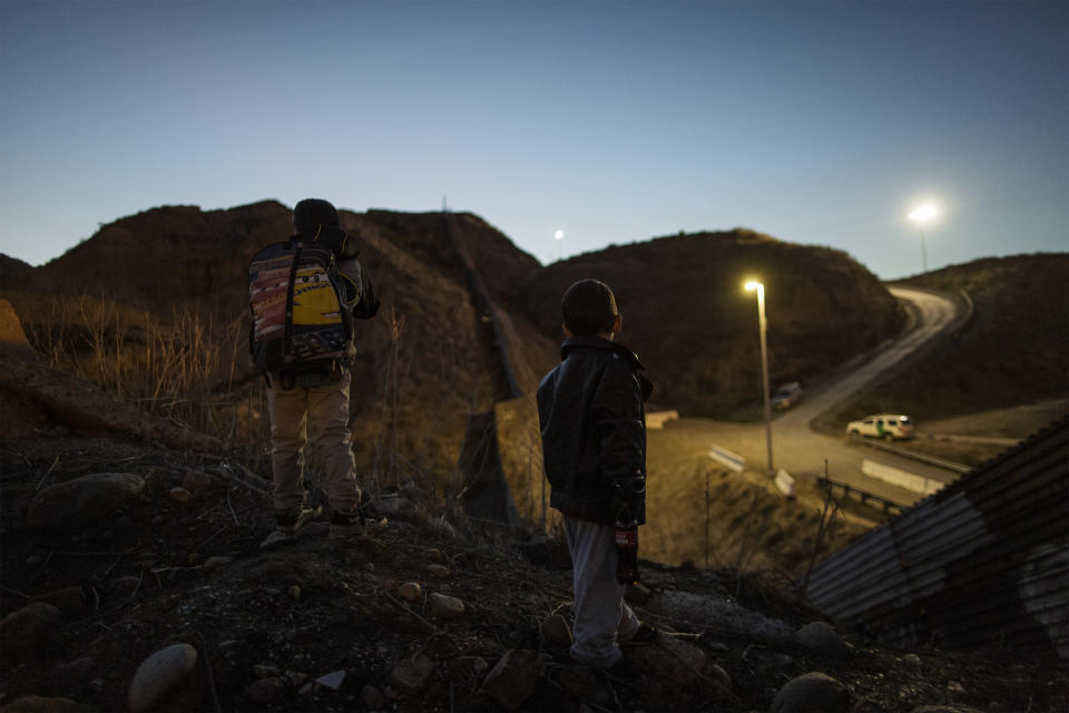 Oliver (7) and Schneider (4) watch the border wall between Mexico and US on December 1, 2018. (Photo: Fabio Bucciarelli for Yahoo News)