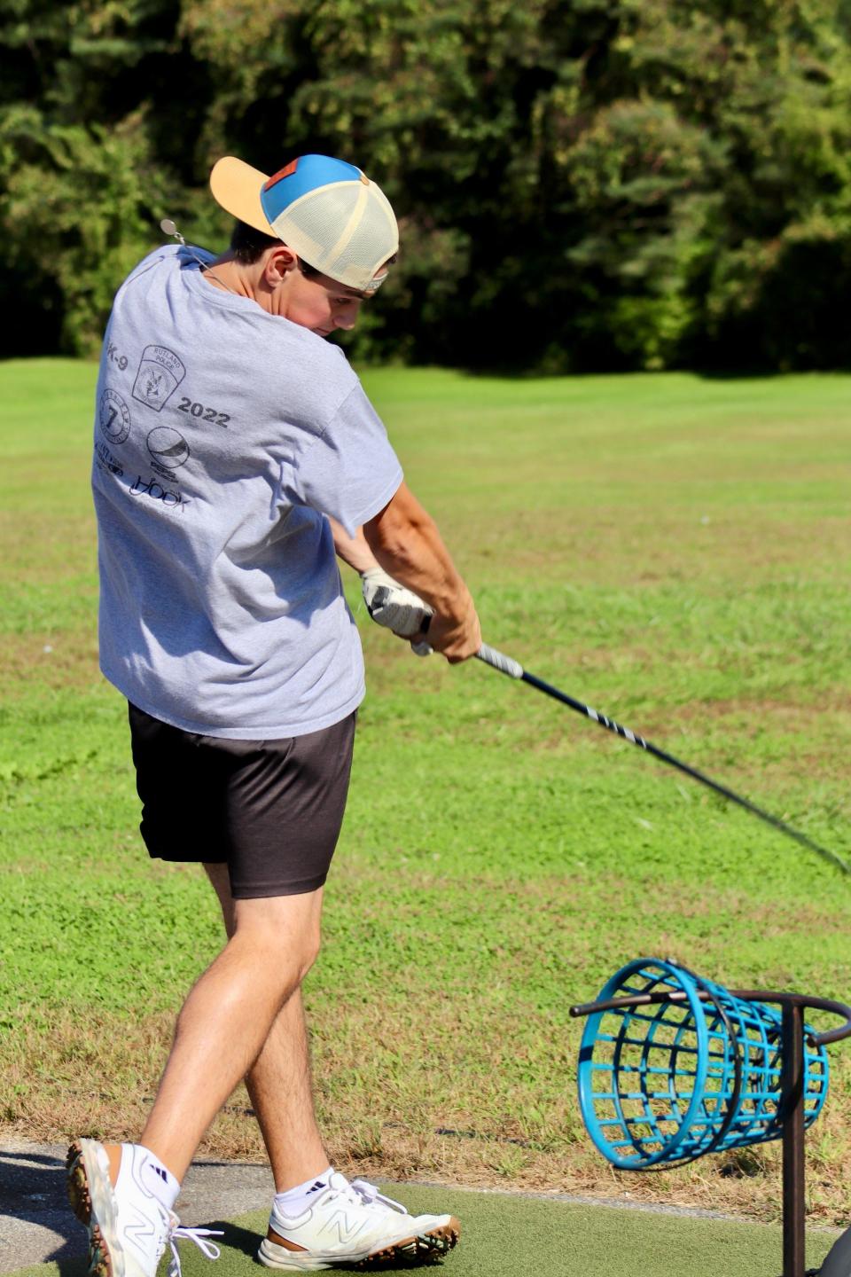 Auburn senior Logan Mulcahy blasts a drive in practice at the Auburn Driving Range.