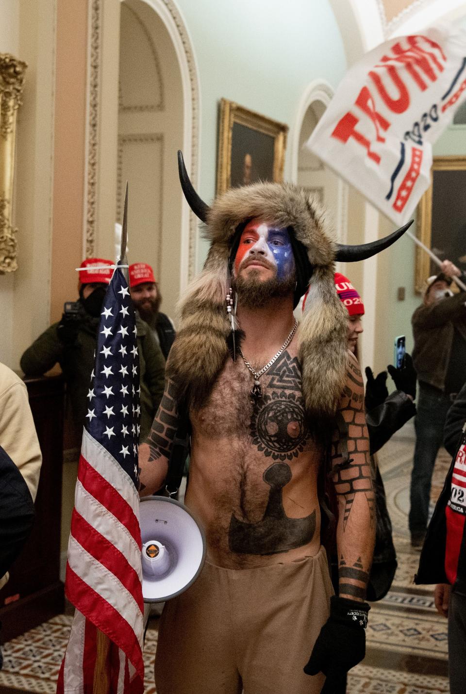 Jake Angeli on Jan. 6 after storming the Capitol as part of the Trump-backed riot. (Photo: SAUL LOEB/AFP via Getty Images)