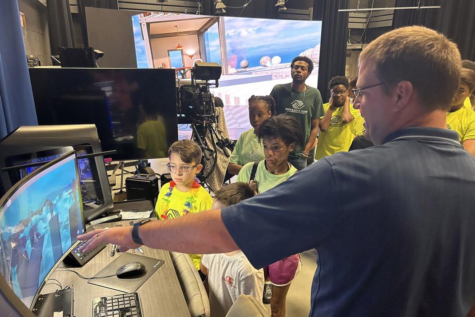 Mike Forbes, right, director of technical systems for the Department of Media Arts at Middle Tennessee State University, gives students from the Boys and Girls Clubs of Rutherford County a tour of the XR Studio in the Bragg Media and Entertainment Building during the recent “Come to Voice” digital literacy summer camp sponsored by the College of Media and Entertainment. The camp brought 20 seventh through ninth graders to MTSU to learn about digital media and other career paths offered at the university in Murfreesboro, Tenn.