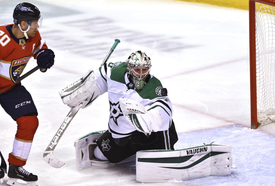Dallas Stars goaltender Anton Khudobin (35) makes a save as Florida Panthers right wing Patric Hornqvist (70) watches during the second period of an NHL hockey game Wednesday, Feb. 24, 2021, in Sunrise, Fla. (AP Photo/Jim Rassol)
