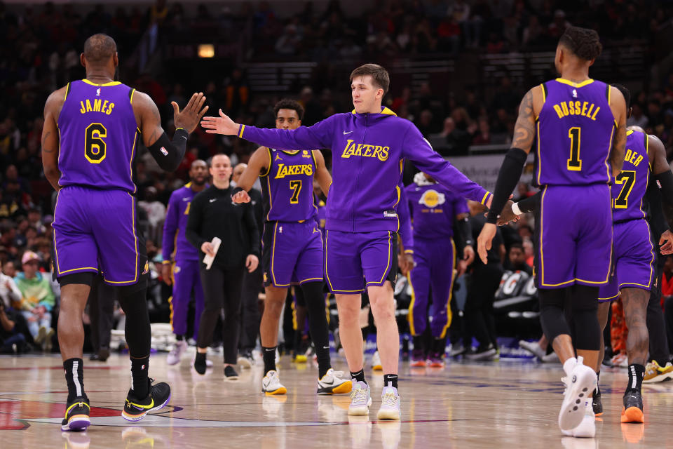 CHICAGO, ILLINOIS - MARCH 29: LeBron James #6 and D'Angelo Russell #1 of the Los Angeles Lakers high five Austin Reaves #15 against the Chicago Bulls during the second half at United Center on March 29, 2023 in Chicago, Illinois. NOTE TO USER: User expressly acknowledges and agrees that, by downloading and or using this photograph, User is consenting to the terms and conditions of the Getty Images License Agreement. (Photo by Michael Reaves/Getty Images)