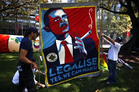 Members of the Help End Marijuana Prohibition (HEMP) Party lift a banner displaying a parody of U.S. President Barack Obama's election campaign poster with the slogan "Legalise - Yes We Can-Nabis" written underneath, during the launch of their national election campaign in central Sydney September 2, 2013. REUTERS/David Gray