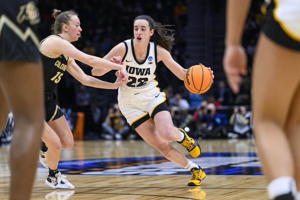 Iowa's Caitlin Clark drives as Colorado's Kindyll Wetta defends during the first quarter of a Sweet 16 college basketball game in the women's NCAA Tournament in Seattle, Friday, March 24, 2023. (AP Photo/Caean Couto)