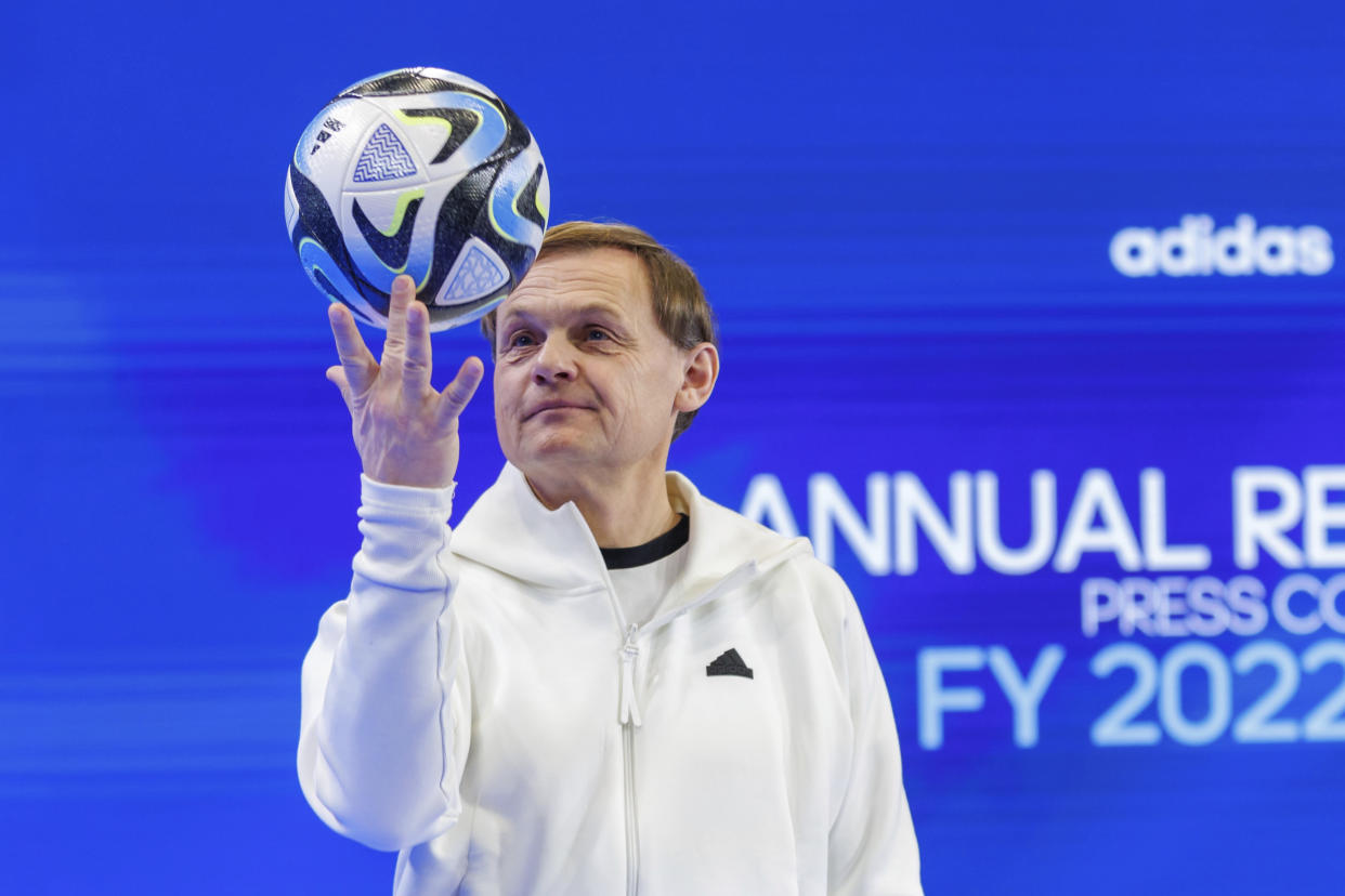 Bjoern Gulden, CEO of sporting goods manufacturer adidas AG, holds the official match ball "OCEAUNZ" of the Women's World Cup in Australia and New Zealand 2023 in his hands on the sidelines of the company's annual press conference in Herzogenaurach, Germany, Wednesday, March 8, 2023. (Daniel Karmann/dpa via AP)