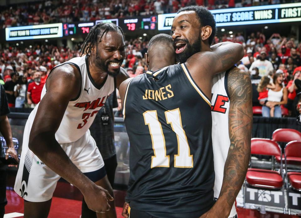 Former UofL player Chris Jones with Jackson TN, gets a hug from former UofL star Russ Smith as teammate Chinanu Onuaku of The Ville gives Jones some encouragement after Jones' team, the Jackson TN Underdawgs, lost to The Ville at the TBT second round of the Louisville Regional at Freedom Hall July 27, 2023. The teams are battling to make it to Philadelphia for a chance at the championship and $1 million for the winning team.